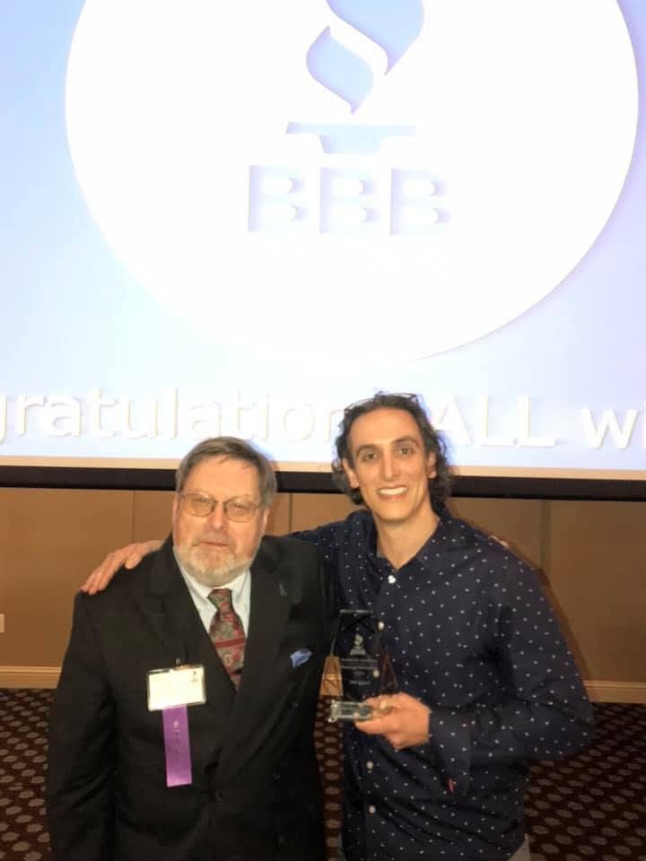 Matthew Bertram receiving a Better Business Bureau award